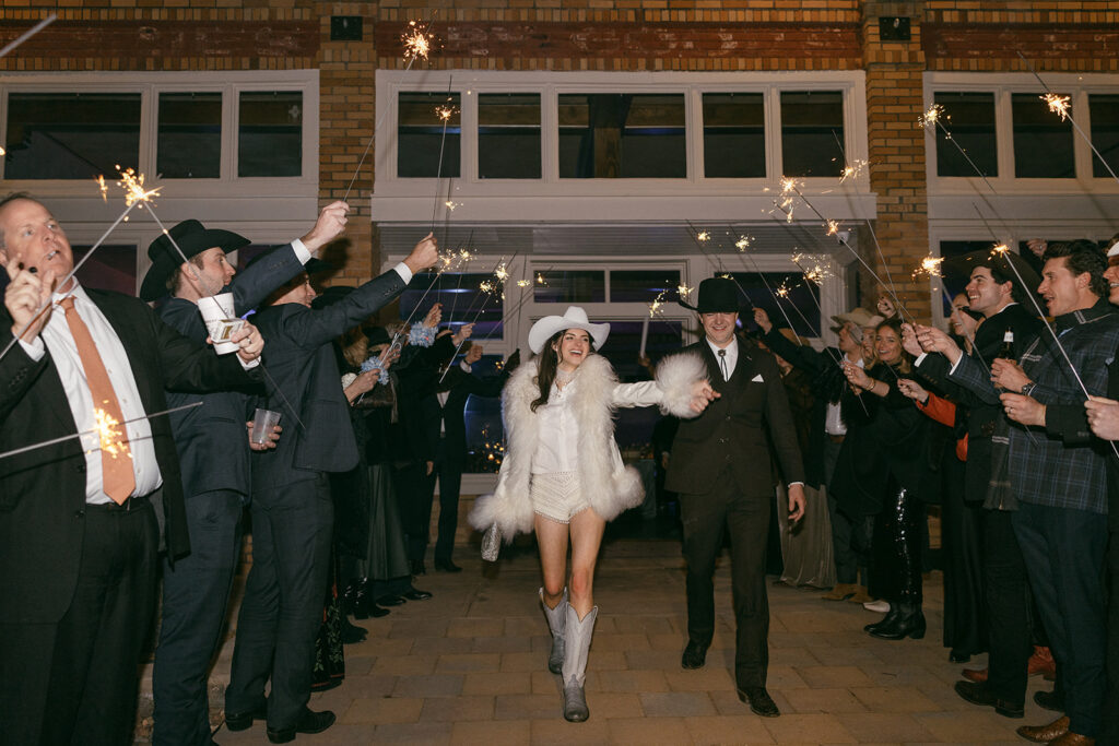 Newlyweds make their exit surrounded outside the Ritchey Building at The Gage Hotel in Marathon, Texas. 