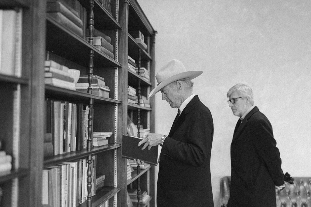 John Bryan, owner of The Gage Hotel, standing among guests at the Ritchey Building in Marathon, Texas.