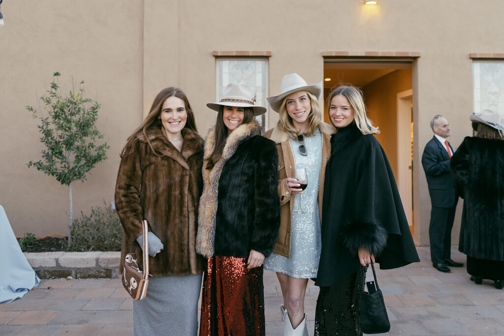 Gage Hotel wedding guest join for a photo at cocktail hour in Marathon, Texas.